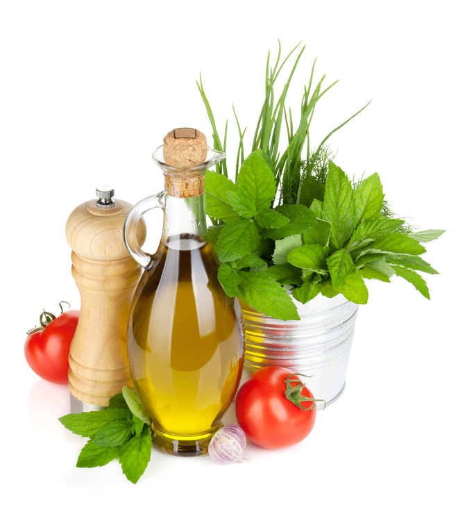 Fresh herbs, tomato, olive oil and pepper shaker
